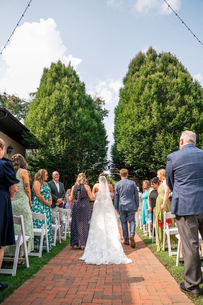 Bride processional from behind at a wedding ceremony at Pinnacle Golf Club in Grove City, Ohio.