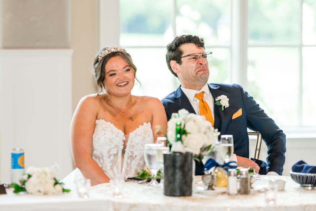 Toasts at a navy and gold themed wedding at Pinnacle Golf Club in Grove City, Ohio.
