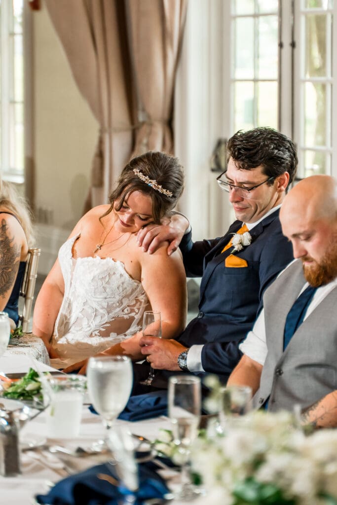 Toasts at a navy and gold themed wedding at Pinnacle Golf Club in Grove City, Ohio.
